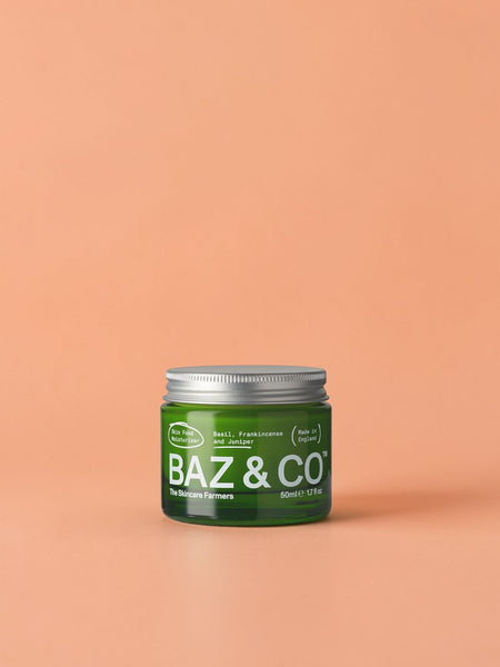 Baz & Co Skincare Skin Food Moisturiser in a green glass jar with a silver lid. Contains basil, frankincense, and juniper.