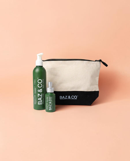 Baz & Co Skincare body wash, deodorant, and canvas wash bag set on a peach background.