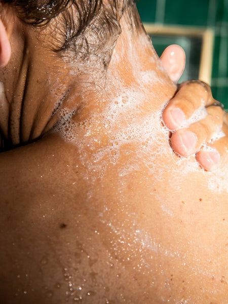 Baz & Co Skincare Restore and Awaken body wash with basil, grapefruit & spearmint scent, lathering on skin.