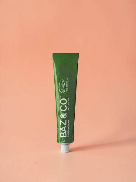 Baz & Co Skincare green tube of 75ml Brightening 2-in-1 Exfoliator & Cleanser with Basil, Aloe Vera & Apple Cider Vinegar.