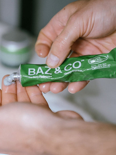 Baz & Co Skincare Brightening 2-in-1 Exfoliator & Cleanser with Basil, Aloe Vera & Apple Cider Vinegar being squeezed onto a hand.