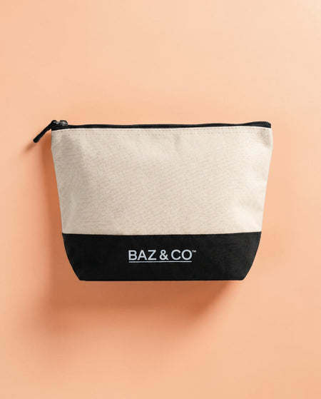 Baz & Co Skincare canvas wash bag, beige with black bottom and zipper, for travel or gym.