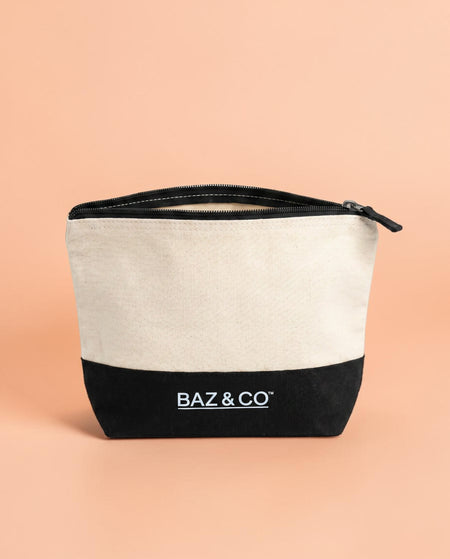 Baz & Co Skincare canvas wash bag with black base and white top, featuring a zip closure.