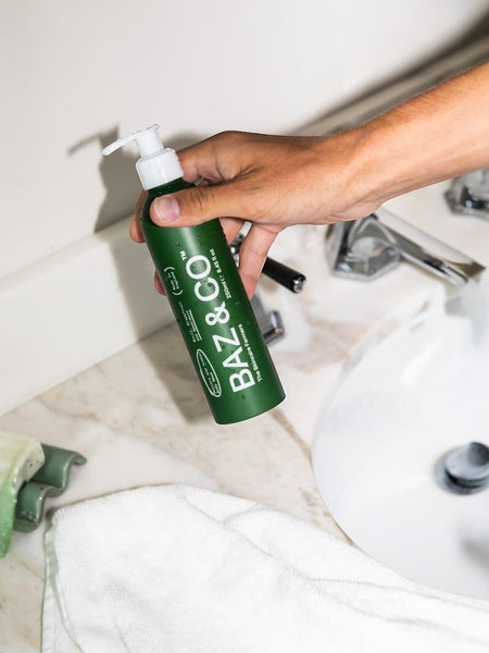 Baz & Co Skincare Restore and Awaken green body wash bottle with basil, grapefruit, and spearmint scent.