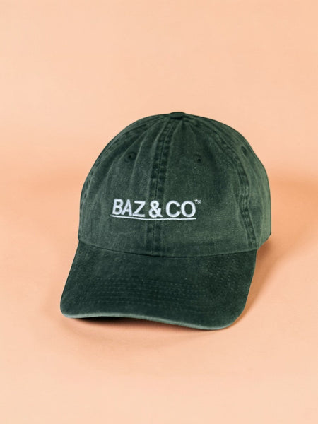 Baz & Co dark green washed cotton baseball cap with white embroidered logo, designed for everyday wear.